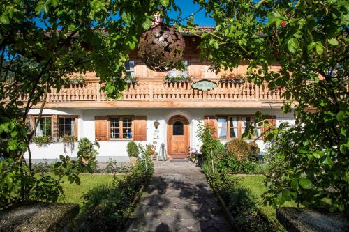 a large house with a pathway in front of it at Gästehaus Becher, Kreuth-Point in Kreuth