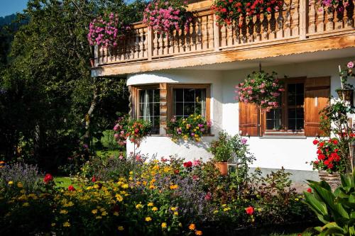 a house with flowers in front of it at Gästehaus Becher, Kreuth-Point in Kreuth