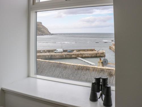 a window with a view of the ocean at Craignure in Banff