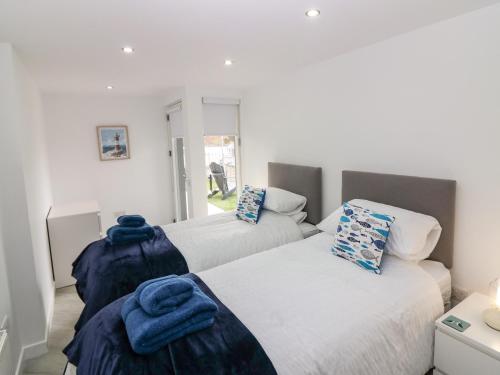 a bedroom with two beds with blue towels on them at Craignure in Banff