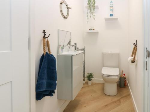 a bathroom with a white toilet and a sink at Craignure in Banff