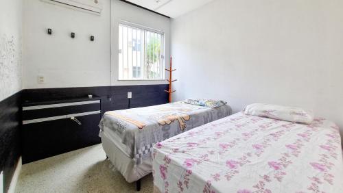 a bedroom with two beds and a window at Apartamento completo COP30 Belém in Belém