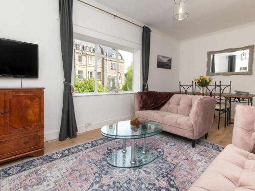 a living room with a couch and a table at Central 2 bedroom flat with parking - Pass the Keys in Bath