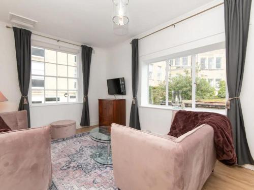 a living room with a couch and a window at Central 2 bedroom flat with parking - Pass the Keys in Bath