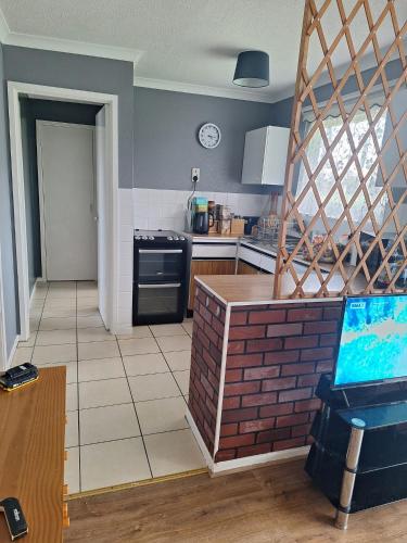 a kitchen with a stove and a counter top at great holidays hemsby in Hemsby