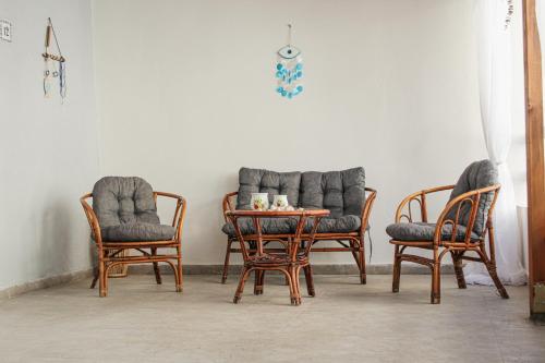 a group of chairs and a table in a room at Aneza in Kremasti