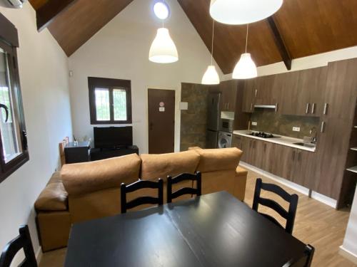 a living room and kitchen with a table and a couch at Casas ROBRA in El Palmar