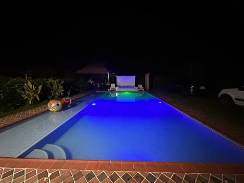 a large blue swimming pool at night at Finca El Duero in Guamal
