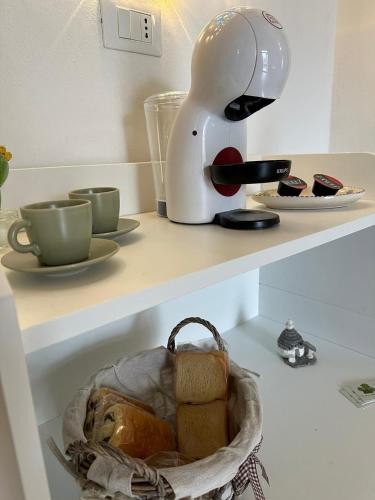 a toaster sitting on a counter with bread in a basket at Un giorno bellissimo suite & spa in Martina Franca