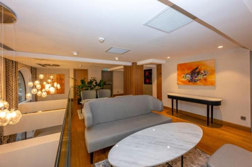 a living room with a couch and a table at Baver Hotel in Istanbul