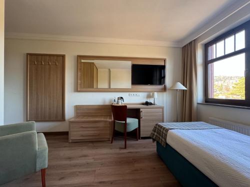 Una cama o camas en una habitación de Greno Hotel & Spa