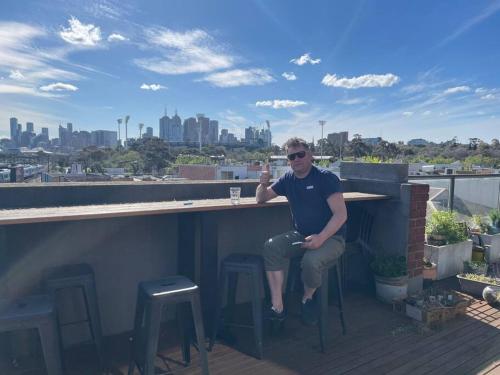 a man sitting at a bar on a rooftop at You won't believe the balcony! in Melbourne