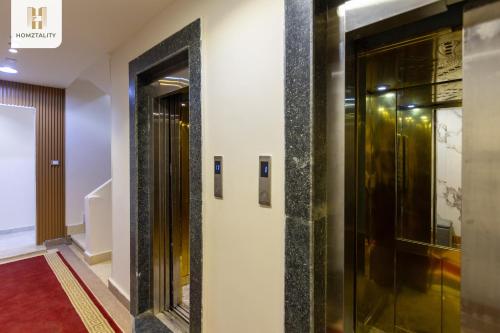 a hallway with two elevators in a building at Homztality Elbatal Mohandeseen in Cairo