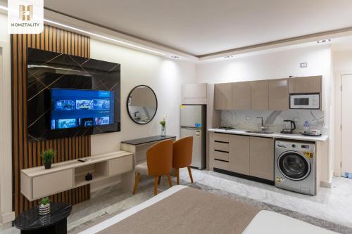a kitchen with a washer and dryer at Homztality Elbatal Mohandeseen in Cairo