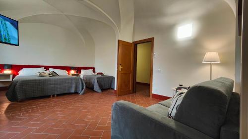 Un ou plusieurs lits dans un hébergement de l'établissement Chiostro Delle Monache Hostel Volterra
