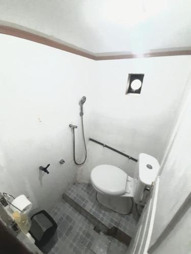 a bathroom with a toilet and a shower at Exploring komodo island in Labuan Bajo