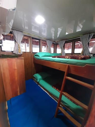 a room with two bunk beds in a boat at Exploring komodo island in Labuan Bajo