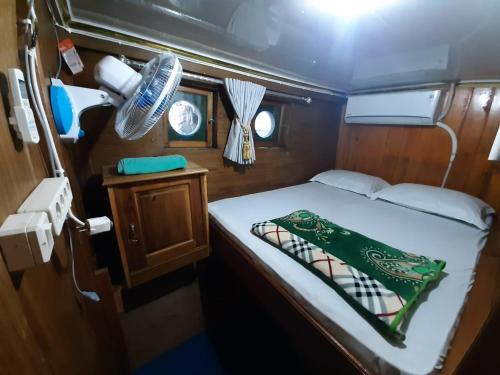 a small bed in the back of a boat at Exploring komodo island in Labuan Bajo