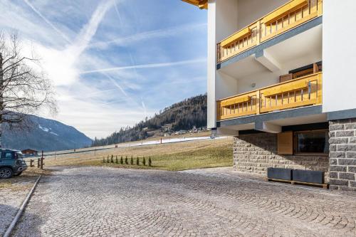 a house on a hill with a stone driveway at Villa Maria Moena in Moena