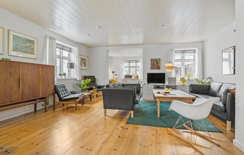 a living room with a couch and a table at 4 Bedroom Cozy Home In Løgstør in Løgstør
