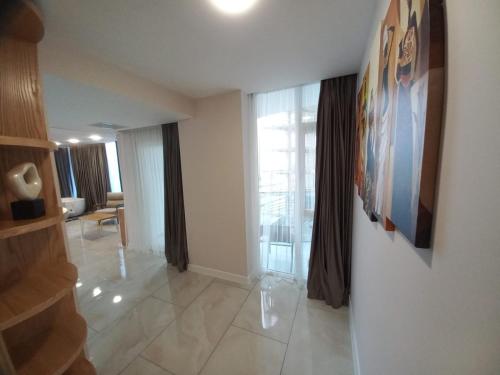 a living room with a staircase and a large window at Hotel Black Sea in Batumi