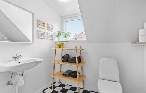 a bathroom with a sink and a toilet at 4 Bedroom Cozy Home In Lgstr in Løgstør