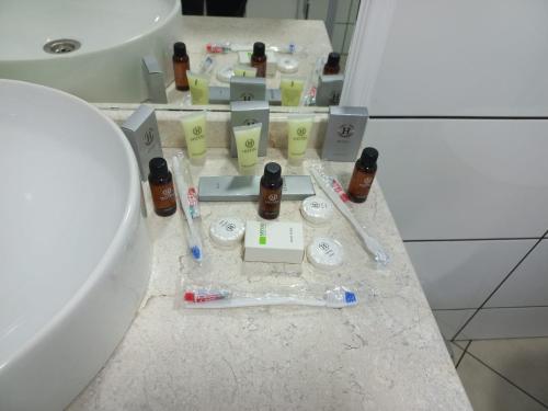 a bathroom with a sink and toiletries on a counter at Hotel Black Sea in Batumi