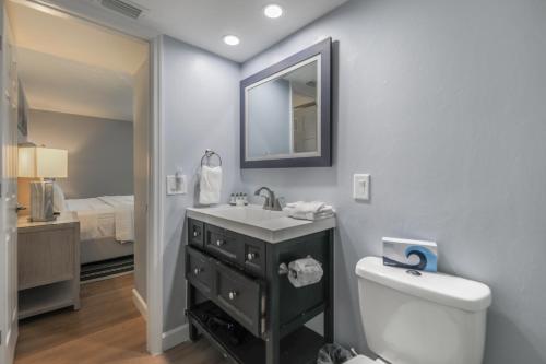a bathroom with a sink and a toilet and a mirror at SOUTH SEAS BEACH VILLA 2428 in Captiva