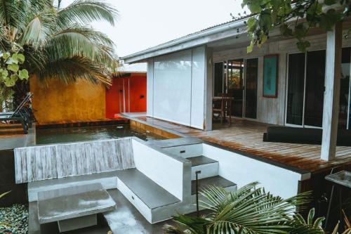 a house with a bench sitting on a deck at Villa Mitirapa in Tohautu