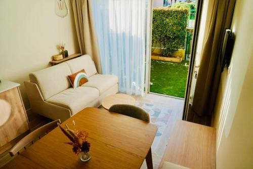 a living room with a couch and a table at Le Bel Iris - Accès direct plage in Châtelaillon-Plage