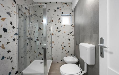 a bathroom with a toilet and a glass shower at Stunning Home In Murter With House Sea View in Murter