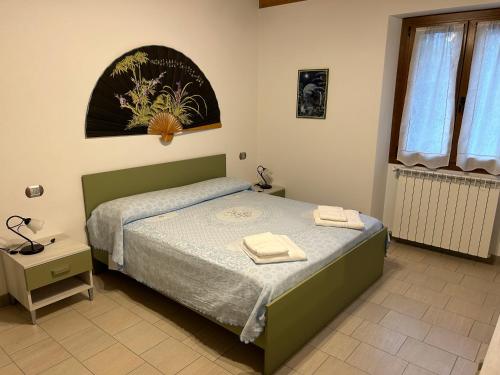 1 dormitorio con 1 cama con 2 toallas en Casa Tartaruga, en Olgiasca