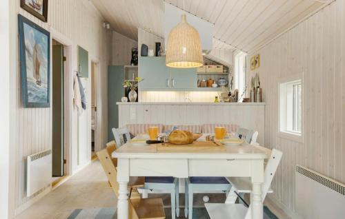 a dining room with a white table and chairs at Beautiful Home In Føllenslev With Wifi in Føllenslev