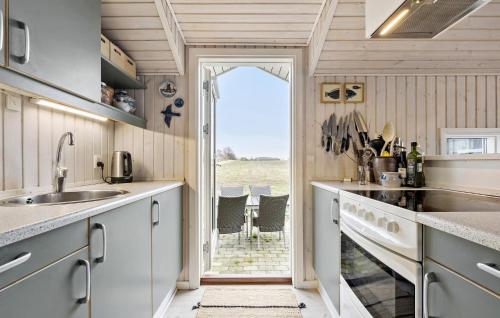 a kitchen with a door leading to a patio at Beautiful Home In Føllenslev With Wifi in Føllenslev