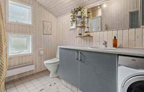 a bathroom with a sink and a washer and dryer at Beautiful Home In Føllenslev With Wifi in Føllenslev