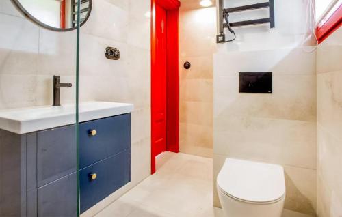 a bathroom with a toilet and a red door at 2 Bedroom Lovely Home In Rowy in Rowy