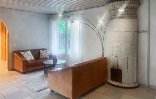 a living room with a couch and a table at Lovely Home In Nybrostrand With Sauna in Glemminge