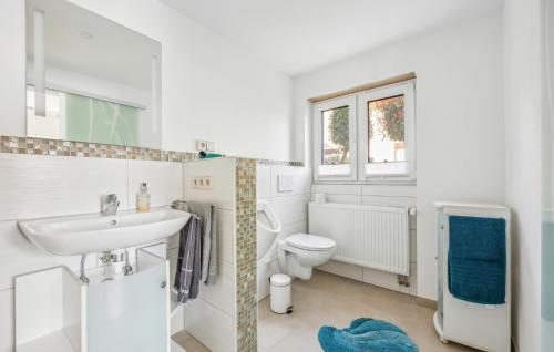 a white bathroom with a sink and a toilet at Nice Apartment In Bretten With Wifi in Bretten
