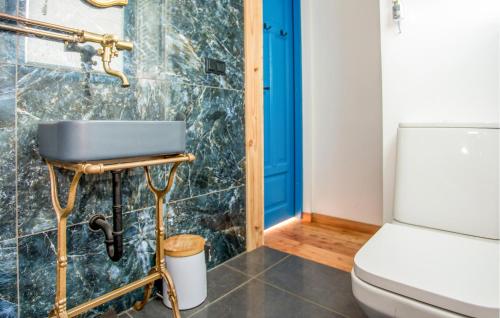 a bathroom with a toilet and a blue door at Awesome Home In Rowy With Wifi in Rowy