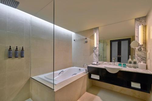 a bathroom with a tub and a sink at The Westin Kuala Lumpur in Kuala Lumpur
