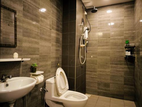 a bathroom with a toilet and a sink at Eshue Designer Suites @ Simfoni Towers in Cheras