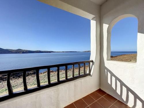 a view of the beach from the balcony of a house at P98 - Bonito apartamento sobre el mar in Fornells