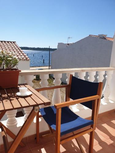 a blue chair sitting on a balcony with a table at F105 · Dos dormitorios, terraza y a/c en Fornells in Fornells