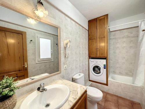 a bathroom with a sink and a washing machine at F105 · Dos dormitorios, terraza y a/c en Fornells in Fornells