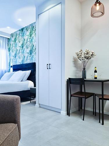 a bedroom with a bed and a table with a table sidx sidx at Stylish Modern Studios - Port & Beach Apartments, Haifa in Haifa