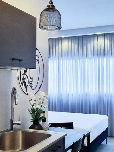 a kitchen with a sink and a table with a sink at Stylish Modern Studios - Port & Beach Apartments, Haifa in Haifa