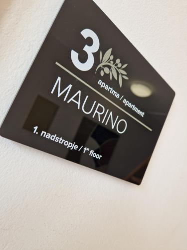 a sign with the name of marino on a wall at House Olive Garden Strunjan in Strunjan