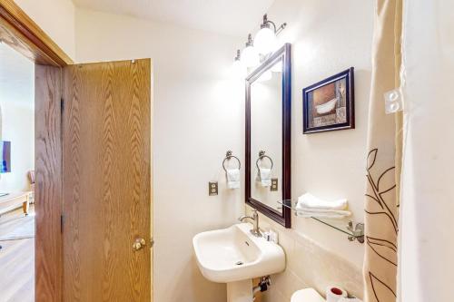 a white bathroom with a sink and a mirror at Timber Ridge 504B in Silverthorne
