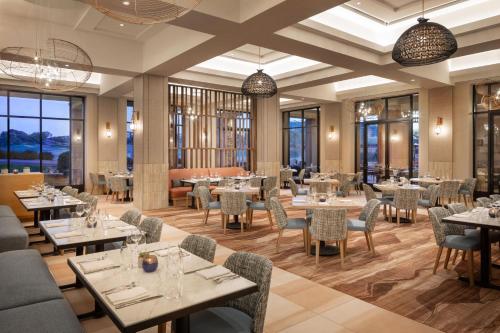 a restaurant with tables and chairs and windows at The Westin Kierland Resort & Spa in Scottsdale