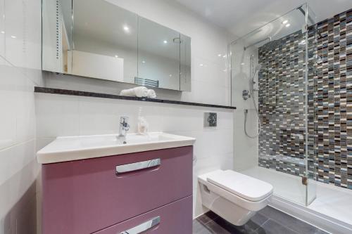 a bathroom with a sink and a toilet and a shower at Beautiful 2Bed Apartment with lift in Kensington in London